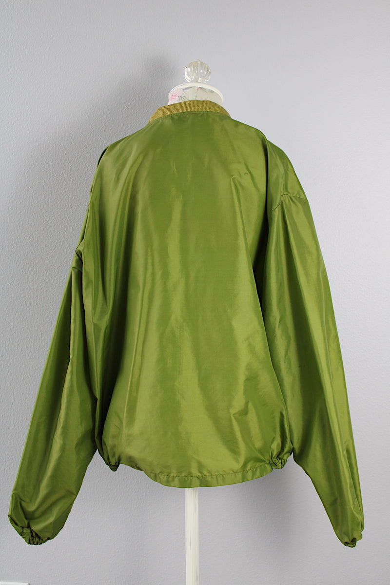 Men's or women's vintage 1960's Puritan Gary Player Sportswear, Made in USA label long sleeve olive green lightweight nylon bomber jacket with a zipper in the front. 