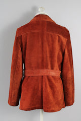 Women's vintage 1970's Genuine Leather, Made in Uruguay label burn orange suede leather zip up jacket with collar and matching tie belt and a faux fur liner