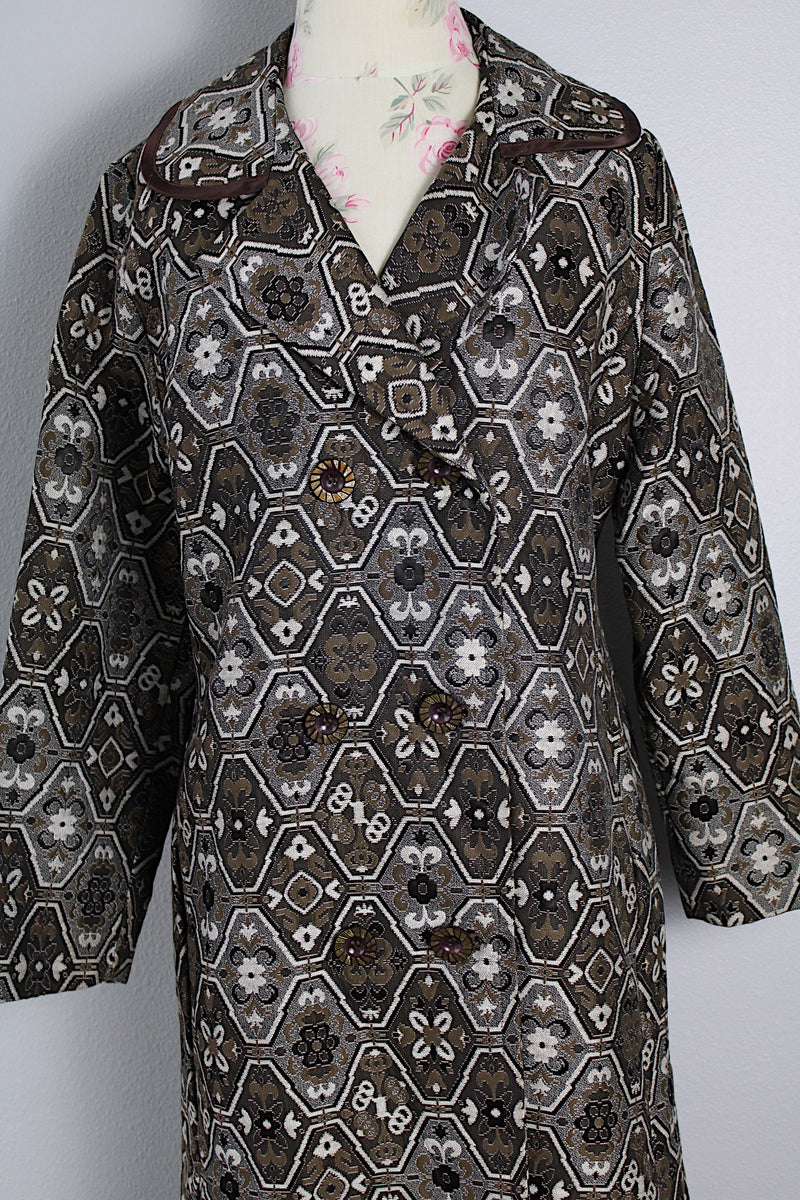 Women's vintage 1960's long sleeve long length brown and white tapestry print coat with a double breasted closure.