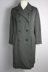 Women's vintage 1960's long sleeve cotton double breasted trench coat in a grey green color.