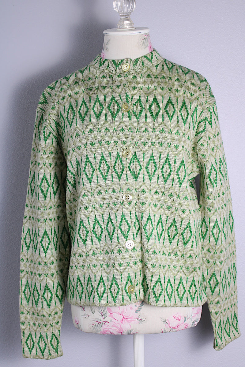 Women's vintage 1960's long sleeve button up cardigan in all wool material. Light green with an all over darker green abstract print.