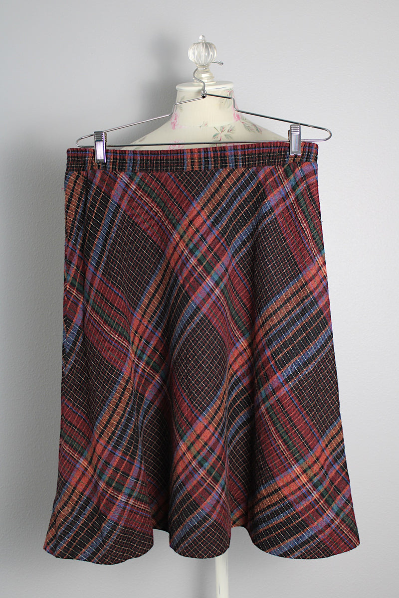 Women's vintage 1990's Take 1 label knee length a-line shaped skirt with elastic waistband in a multicolored plaid print in a polyester acrylic blend material.