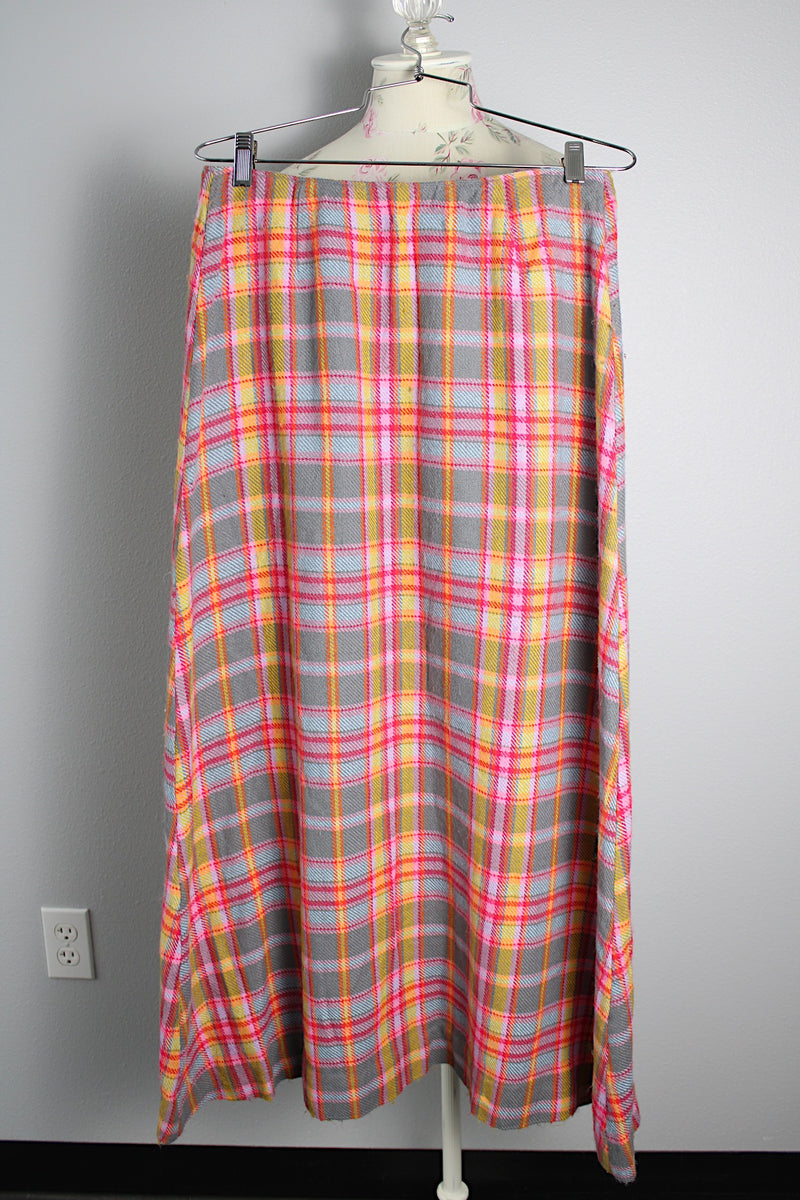 Women's vintage 1970's ankle length maxi skirt in an acrylic material with plaid print and a-line shape.
