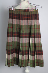 Women's vintage 1960's wool material pleated knee length skirt in brown, green, and orange all over plaid print