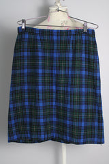 Women's vintage 1970's high waisted knee length wool plaid print pencil skirt. Blue with dark green, white, and black plaid print