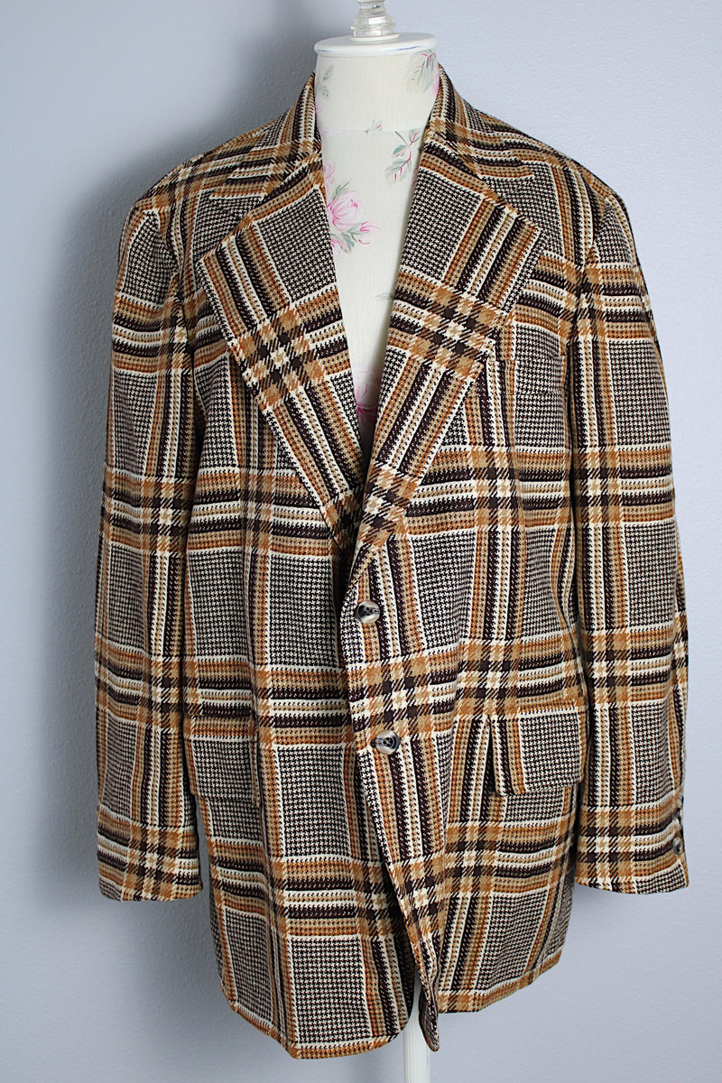 Men's vintage 1960's The Squire Shop long sleeve wool plaid print blazer with a two button closure and double lapel. Plaid print is various shades of brown. 