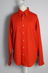 Men's or women's vintage 1970's Manhattan Traditionals long sleeve button up shirt with pointy collar in a red orange tomato color in a polyester cotton blend material with one left chest pocket. 
