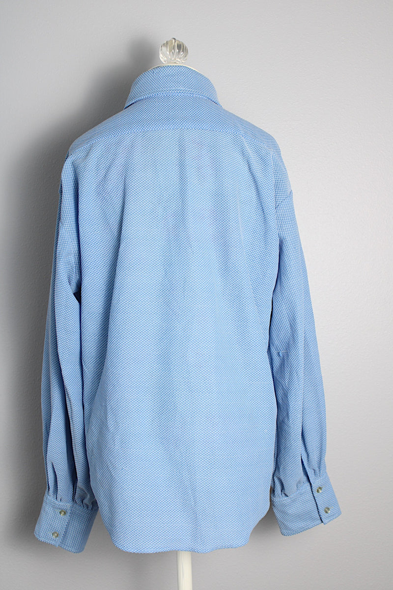 Men's or women's vintage 1970's long sleeve light blue polyester button up shirt with very pointy dagger collar and puff sleeves. 