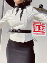 long sleeve white leather 1980's wilsons jacket with black trim and black belt asymmetrical zipper women's vintage