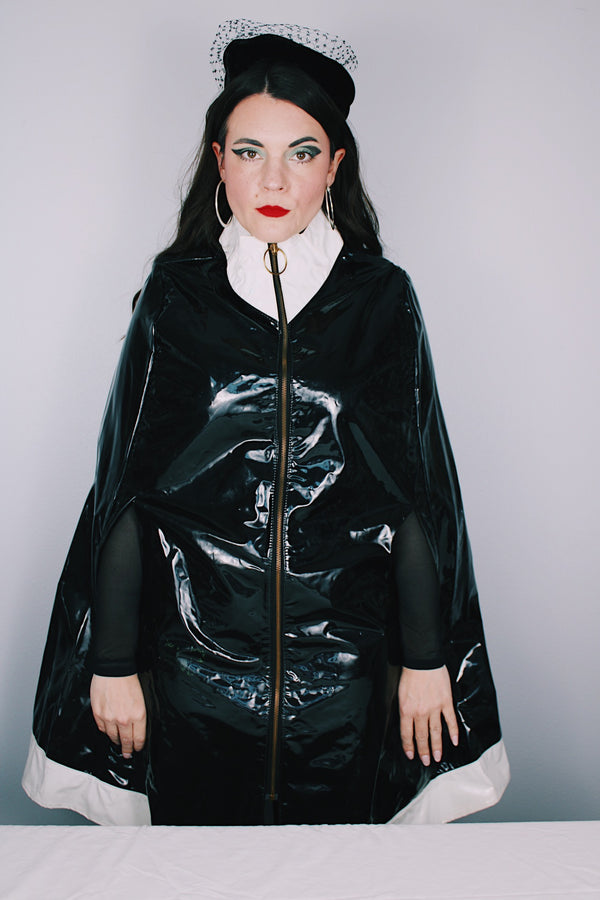 Women's vintage 1960's Aqua-Sheen by Exylin Co., Made in USA label vinyl material  poncho with shiny exterior in black and white.