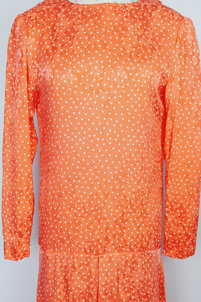 long sleeve orange silk dress with polka dot print and asymmetrical hem vintage 1980's