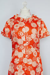 short sleeve maxi length orange printed dress with ruffle trim vintage 1970's