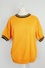 short sleeve orange pullover crew neck with navy striped trim around cuffs and neck vintage 1970's