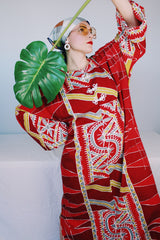 Women's vintage 1970's long sleeve printed cotton muu muu dress in red, green, grey, and white.
