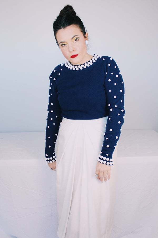 Women's vintage 1960's long sleeve midi length twofer dress with a navy cashmere top half and white polyester skirt. White beads all over top part.