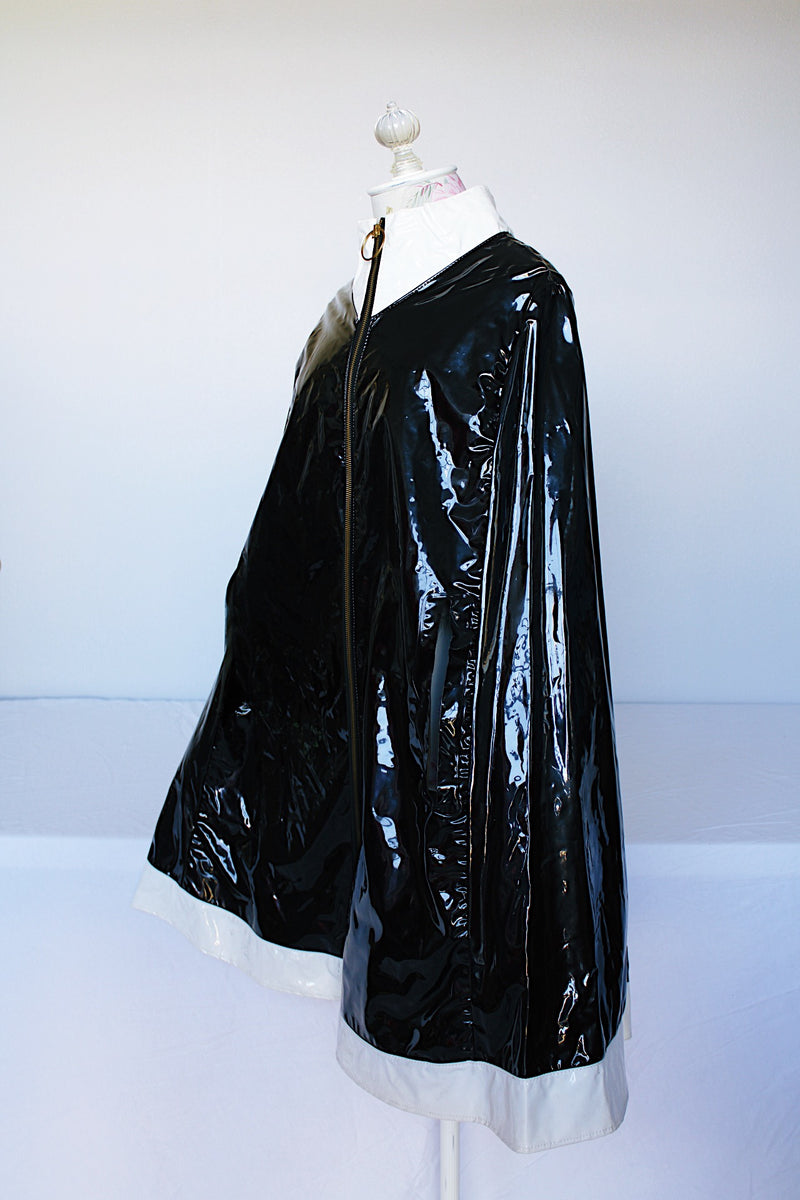 Women's vintage 1960's Aqua-Sheen by Exylin Co., Made in USA label vinyl material  poncho with shiny exterior in black and white.