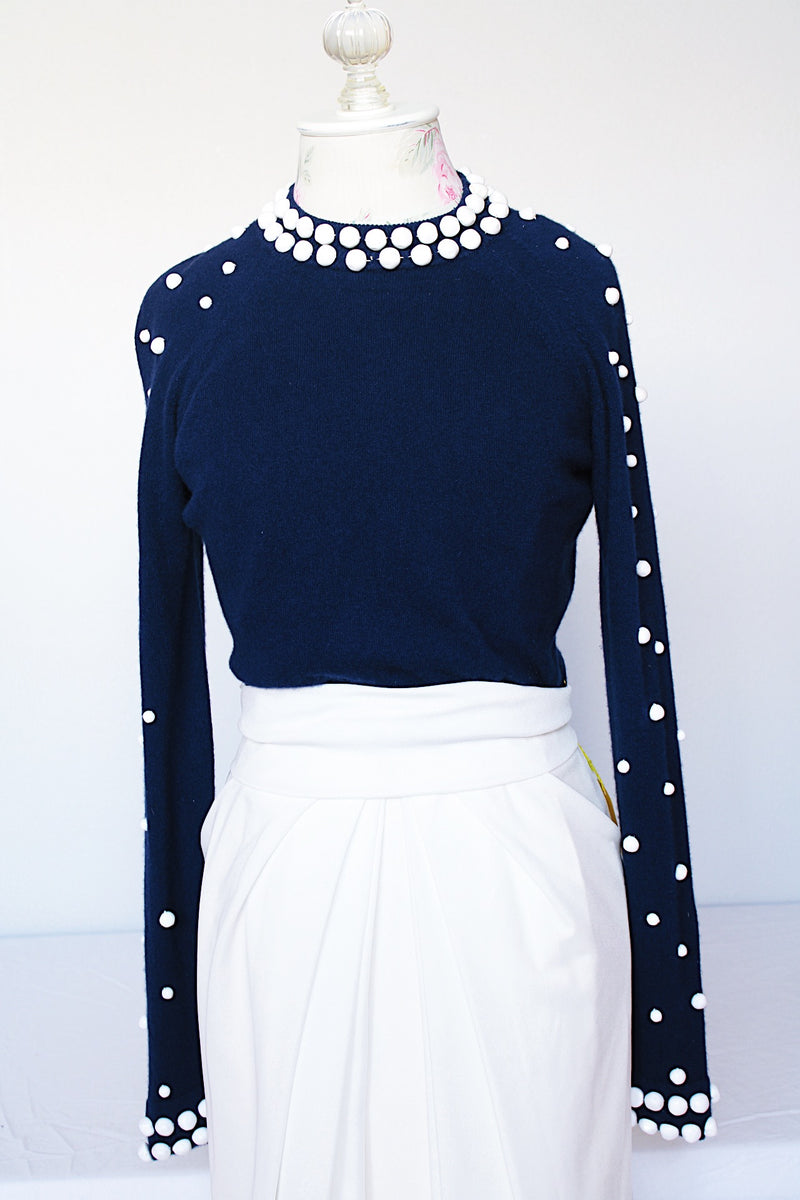 Women's vintage 1960's long sleeve midi length twofer dress with a navy cashmere top half and white polyester skirt. White beads all over top part.