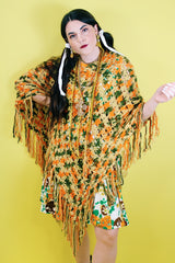Women's vintage 1970's acrylic knit multicolored poncho with a long fringe trim hem, drawstring at neck, and V shaped neckline in orange, mustard yellow, and olive  green colors.