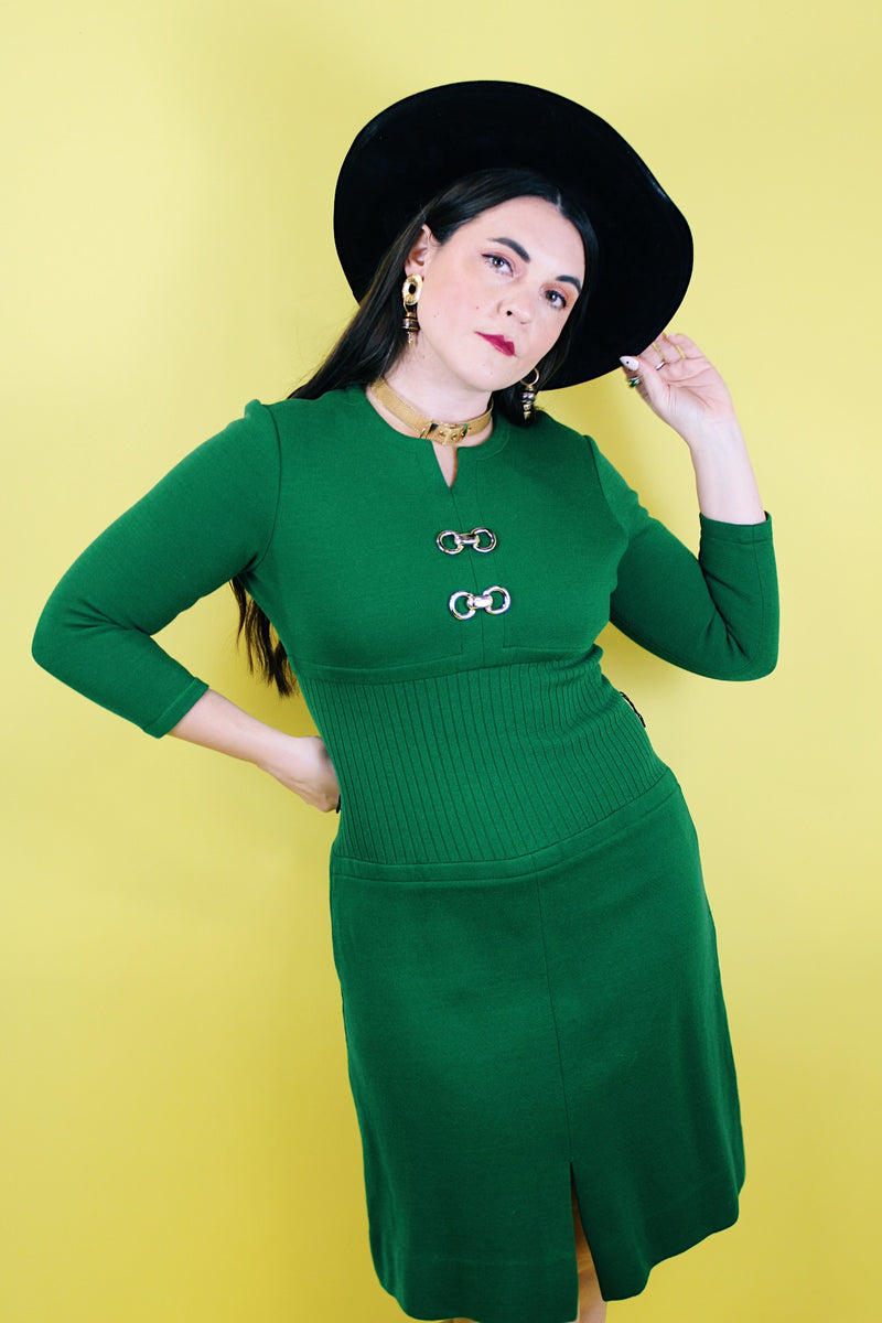 Women's vintage 1960's Dalton label long sleeve knee length green wool dress with a ribbed mid section and gold hardware detail on chest. 