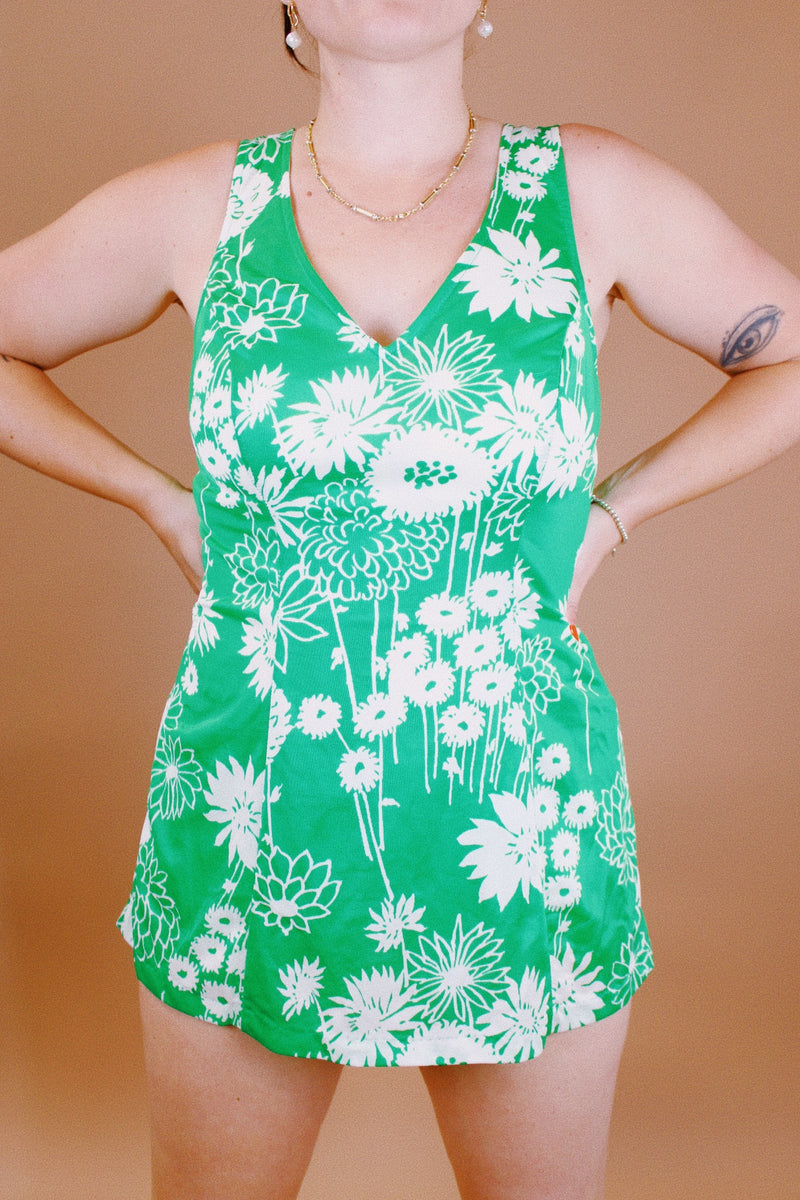 sleeveless vintage 1960's one piece swimsuit with skirt over bottoms in front and back green with white floral print