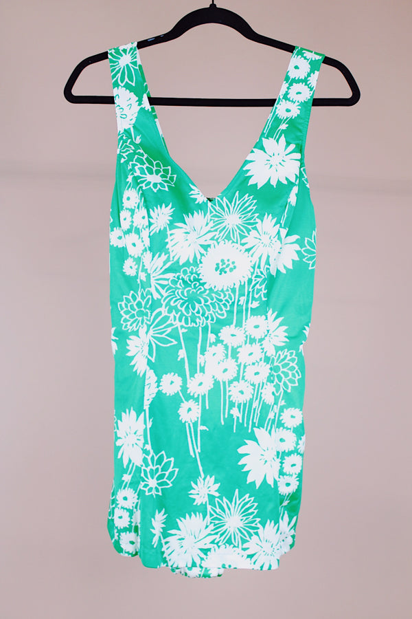 sleeveless vintage 1960's one piece swimsuit with skirt over bottoms in front and back green with white floral print