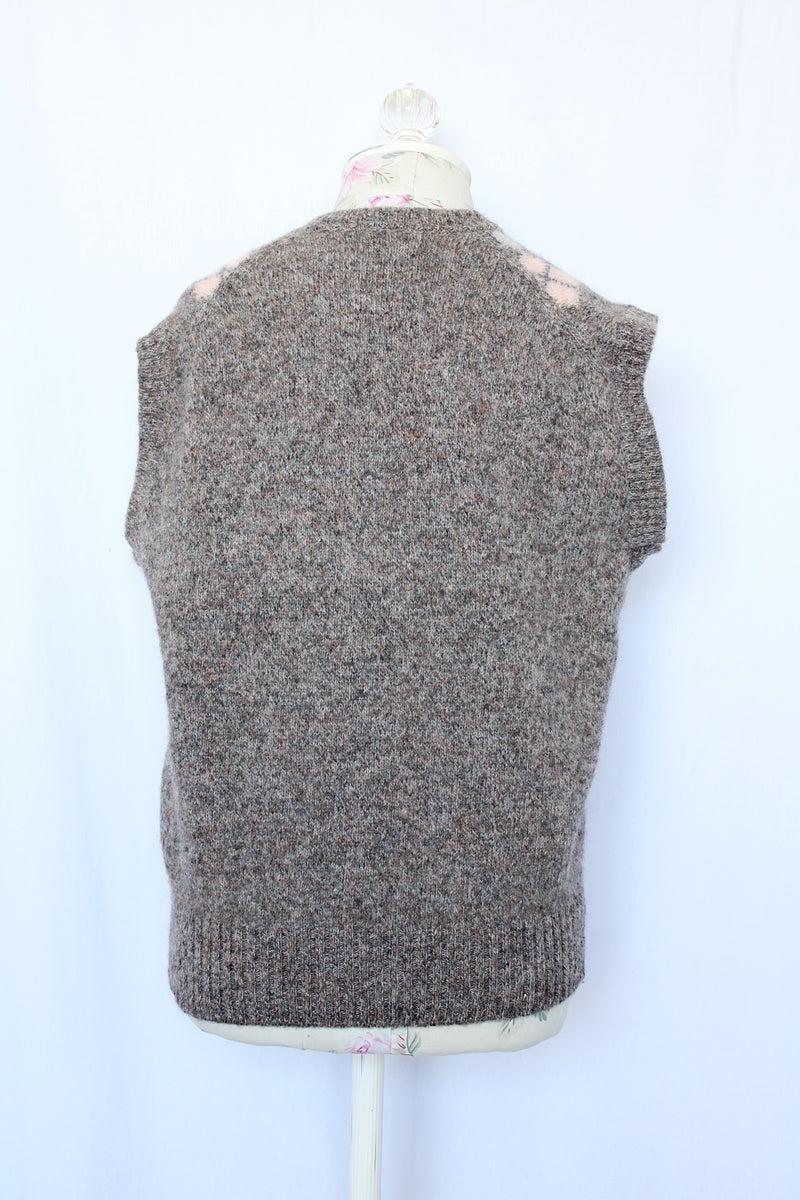 Women's or men's vintage 1970's Churchill Downs, Made in England label sleeveless sweater vest in grey wool with light pink and light blue argyle print on the front.