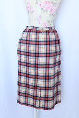 Women's vintage 1970's Weathervane label knee length pencil skirt in wool material, fully lined, cream color with red, navy, and blue plaid print.