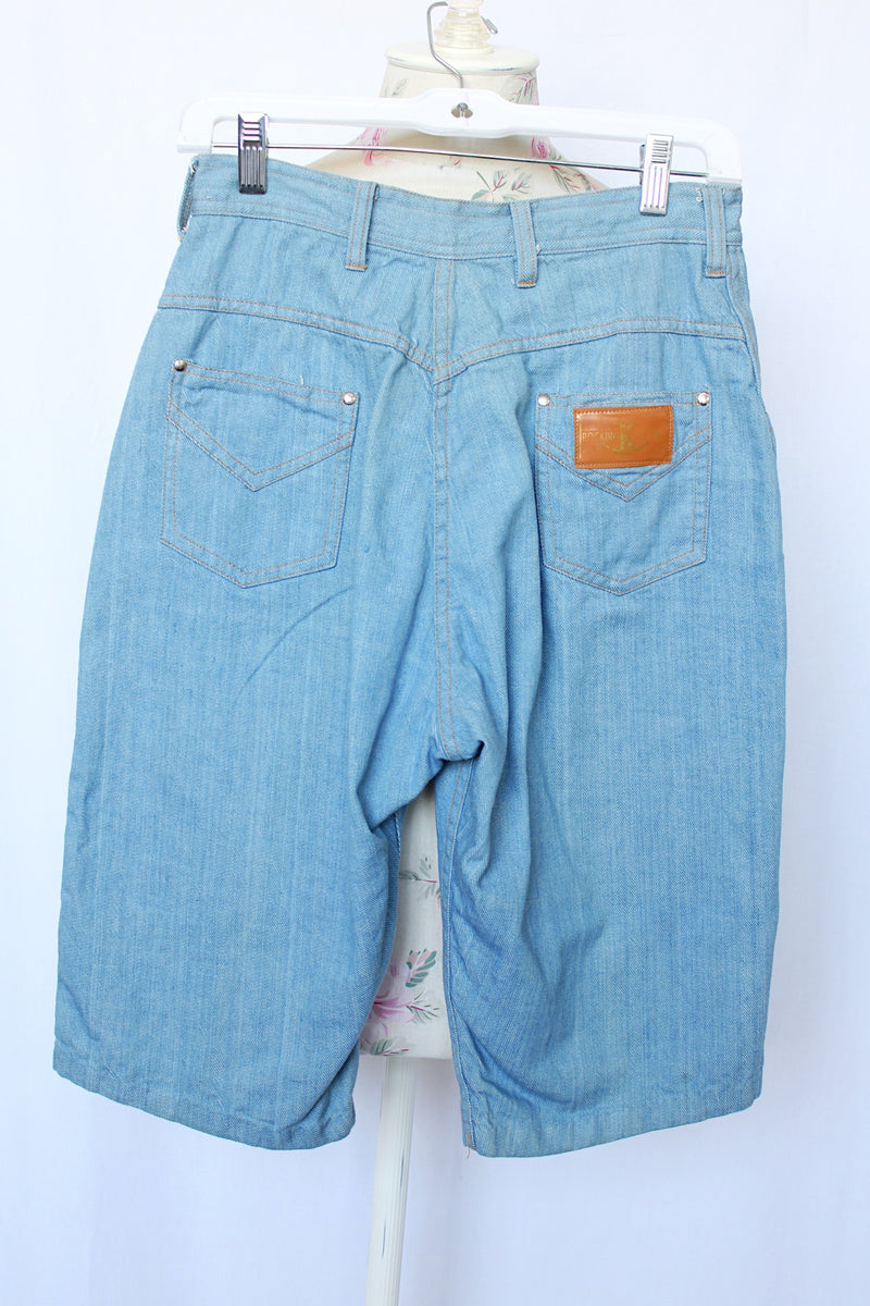 Women's vintage 1980's Rocking Brand label knee length light blue denim bermuda shorts with zipper and button closure in the front.