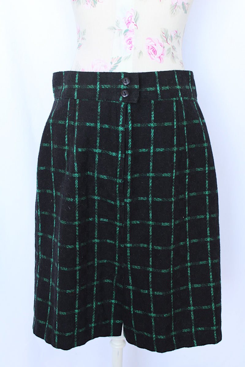 Women's vintage 1970's Made in USA label black knee length pencil skirt with bright green checkered plaid print in a wool and polyester blend material.