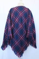 Women's vintage 1970's one size fits most navy and purple plaid print poncho with fringe hem trim and button closure on shoulder in acrylic material.