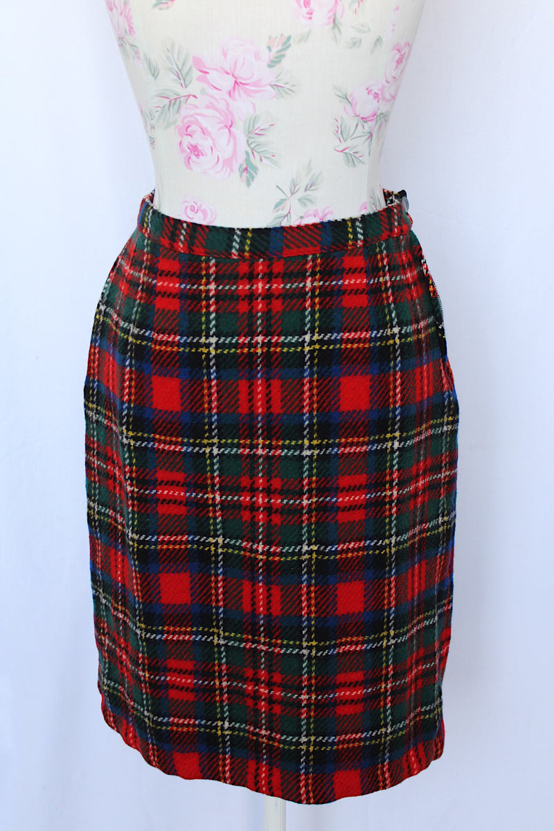 Women's vintage 1970's knee length pencil skirt in an acrylic material in red, blue, yellow, and white all over tartan plaid print.