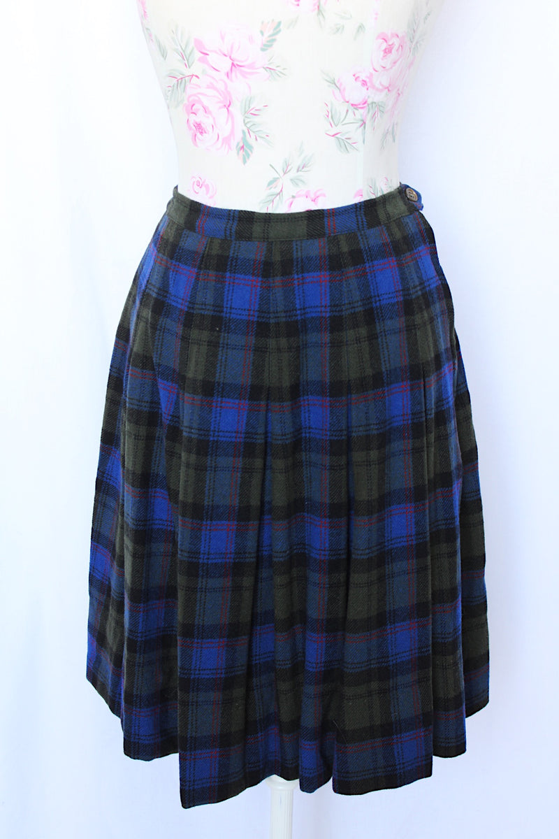 Women's vintage 1970's Lipman's Caliente Shop, Century of Boston label pleated wool knee length skirt in blue, forest green, red, and black plaid print. 