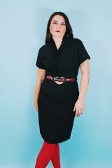 Women's vintage 1960's A Topaz Original label short sleeve knee length black polyester shift dress with a ruffle trim v shaped neckline.
