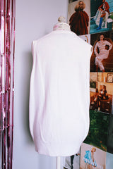 sleeveless white sweater vest with v neck with crest on left chest vintage 1970's 