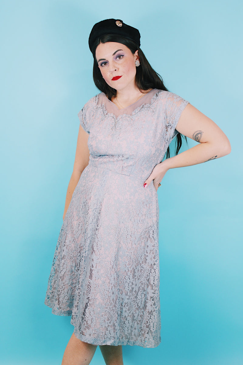 Women's vintage 1950's capped sleeved midi length lace fancy dress. Fully lined in lilac polyester with baby blue lace overlay. 