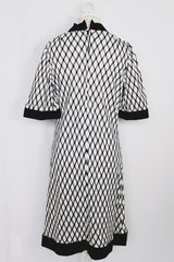 Women's vintage 1970's Mode O'Day, Styled in California label short sleeve mini length dress in black and white polyester material with diamond checkered print. 