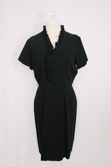 Women's vintage 1960's A Topaz Original label short sleeve knee length black polyester shift dress with a ruffle trim v shaped neckline.