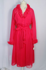 Women's vintage 1970's long sleeve midi length bright pink sheer dress with half button closure and ruffle trim around neckline and cuffs. 