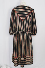 Women's vintage 1980's Walden Classics, Made in USA label 3/4 arm length midi length black striped dress with cinched waist, buttons on shoulders and triangle flap in front and back.