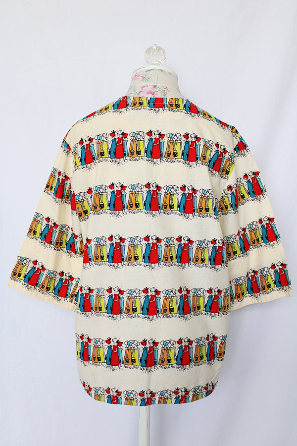 Women's vintage 1970's Kerrybrooke (sub brand of Sears) label 3/4 length sleeves cream colored cotton tunic blouse with all over multi colored maid print.
