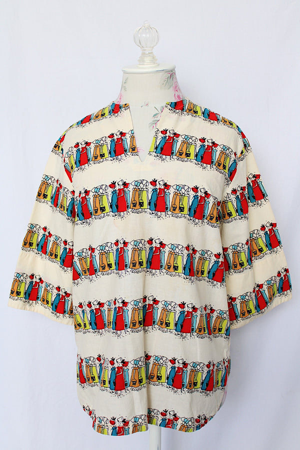 Women's vintage 1970's Kerrybrooke (sub brand of Sears) label 3/4 length sleeves cream colored cotton tunic blouse with all over multi colored maid print.