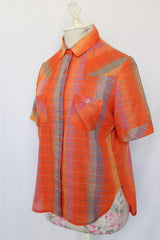Women's vintage 1970's Aaron Ashley label short sleeve button up blouse with collar, two chest pockets, and side slits. 