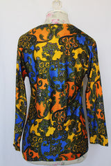 Women's vintage 1970's long sleeve all over paisley print blouse with V shaped neckline in slinky polyester material.