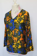 Women's vintage 1970's long sleeve all over paisley print blouse with V shaped neckline in slinky polyester material.