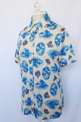 Women's vintage 1970's Montgomery Ward short sleeve button up printed blouse collared blouse. Cream with all over blue print. 
