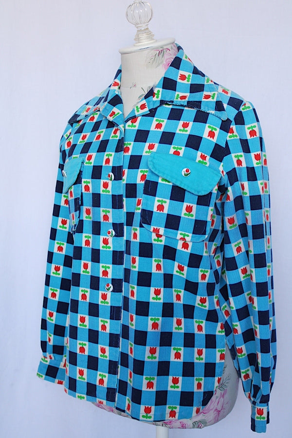 Women's vintage 1970's long sleeve button up corduroy blouse with collar. Blue and navy checkered gingham print with small roses.
