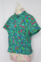 Women's vintage 1960's Majorette short sleeve blouse with buttons in the back, attached tie bow on neck.