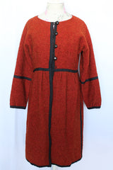 Women's vintage 1970's Fog Eater, Block Island, Tuscon label long sleeve orange textured half button closure jacket with black trim trim detail.
