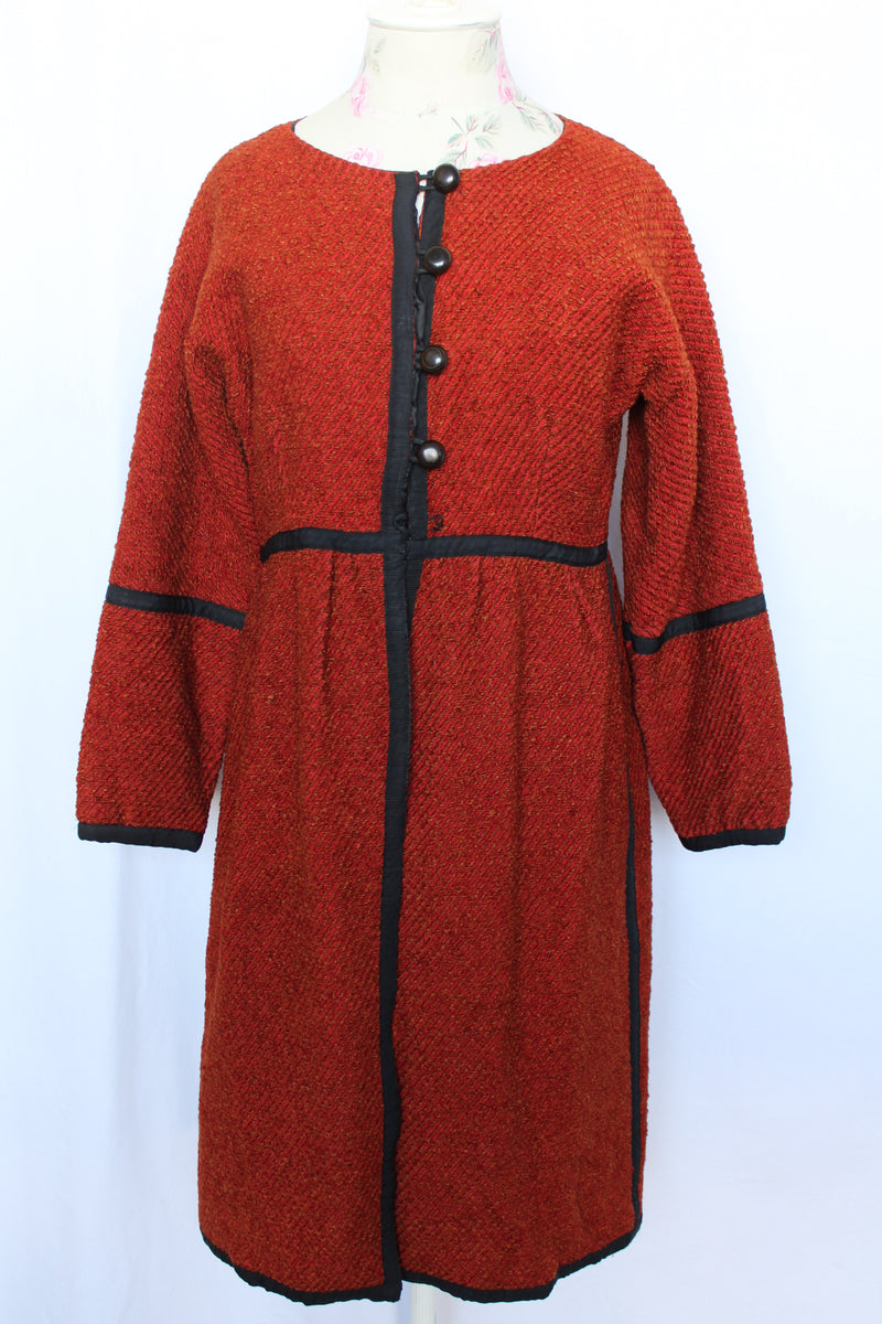 Women's vintage 1970's Fog Eater, Block Island, Tuscon label long sleeve orange textured half button closure jacket with black trim trim detail.