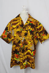 Women's or men's vintage 1970's short sleeve button up Hawaiian print shirt in yellow and brown colors. 